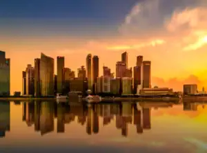 Sunset skyline of modern high-rise buildings reflected on the water, symbolizing ARCSA Capital’s Prime Residential Value-Add investment approach in Miami