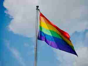 Pride flag flowing in the sky symbolizing the supportive and affirming environment offered by LGBT therapy in Ann Arbor, MI with LGBTQ-friendly therapists.