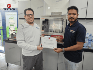 Testron engineer installing hot wire bottle cutter and handing over training certificate at Masafi UAE