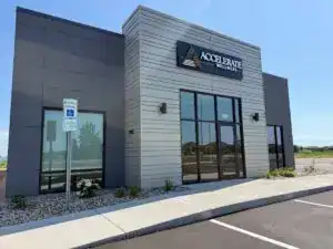 Front exterior of the Accelerate Wellness clinic building in Sioux Falls, featuring modern architecture and a visible ADA parking sign.