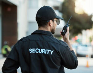 Security guard communicating by radio while on patrol