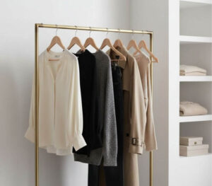 A small rail of a capsule closet of clothes in an hourly personal styling session