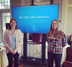 Speaking Engagements Speaking Engagements | Professional home organizers Blanka Molnar and Stephanie King presenting "New Year, New Intentions" at a conference, standing in front of a large screen, promoting organization and self-improvement.