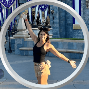 Disney theme park visitor celebrating outdoors at Magic Kingdom outdoors.