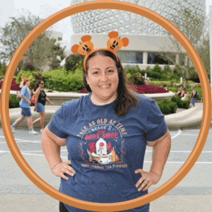 Cute woman wearing Mickey Mouse ears at Epcot, Disney World, must-have Disney vacation experience.