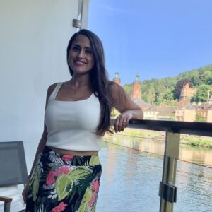 Relaxed woman enjoying scenic river view in Germany, perfect for vacation rentals and travel experiences.
