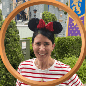Minnie Mouse ears headband at Disney theme park with castle background.