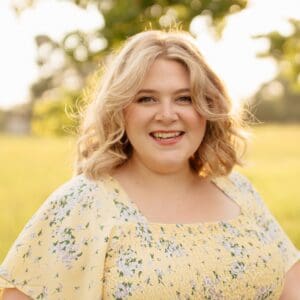 Portrait of Lara Thompson smiling outdoors in natural sunlight.