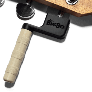Guitar string winder in black and beige winding guitar strings