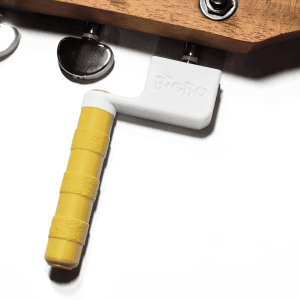 Guitar string winder in yellow and white winding guitar strings