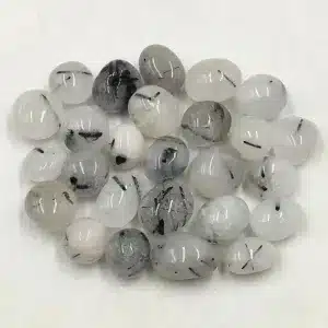 A smooth, deep black tumbled stone of Black Tourmaline, showing a shiny, rounded surface.