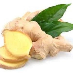 Angel’s Mist Ginger Essential Oil, fresh ginger root with green leaves.