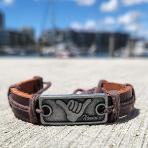 Shaka Leather Bracelet, leather bracelet with a Hawaii-themed metal charm featuring the shaka hand sign.