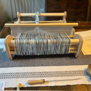 Warped loom on table with hook