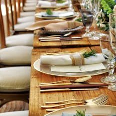 Close-up of a beautifully arranged table setting with flowers and cutlery, perfect for weddings or fine dining.