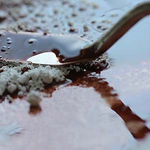 Barite (barium sulfate) being added to oil paint during pigment preparation