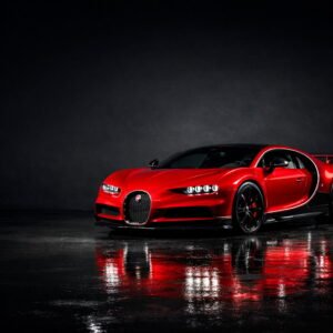 Red Bugatti Chiron hypercar with black back ground