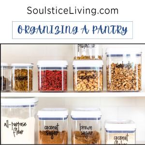 Organizing pantry with clear labeled jars for nuts, dried fruit, spices, and flours in a modern kitchen. Well-organized storage solutions promote easy access and meal prep.