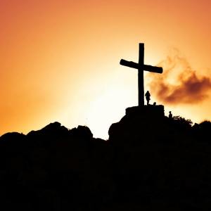 pexels-photo-415571 human standing beside crucifix statue on mountain