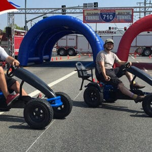 A pair of pedal pursuit cars at a fun outdoor event in Los Angeles. Perfect for corporate parties, f.