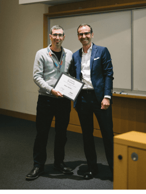 Adam Shlien receives a certificate from Ihor Boszko as the winner of the audience choice award
