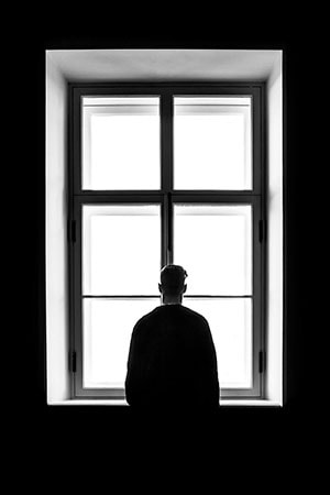 silhouette of a man against the background of a window