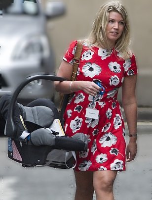 Image of a mom carrying a baby carrier incorrectly