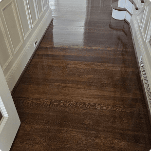Dark stained wood floors in a hallway