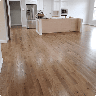 Wide plank wood floors in open kitchen