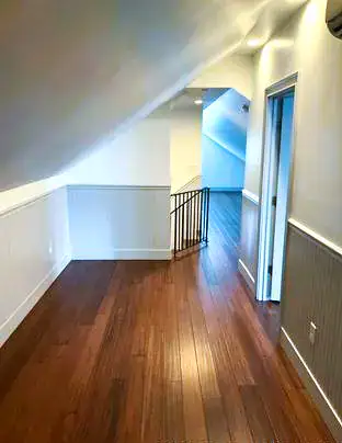 Clean empty-home hallway and hardwood floor after DSS Cleaning service in Charleston