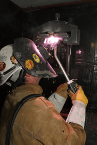 Image of a welder using a self-shielding application