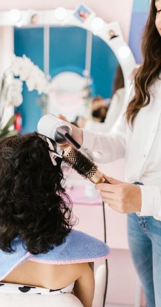 Hair dresser brushing a client's hair