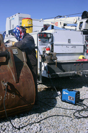 Image of a novice welder in front of a work truck