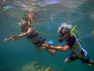 SNUBA guide staying close to a participant beneath the surface in St. Maarten