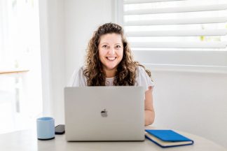 Marketing Strategist and Content creator -Woman sitting in front of a computer.