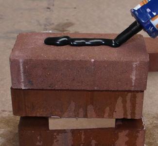 applying Adiseal brick adhesive on brick