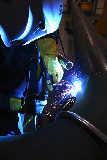 Image of a person welding with a MIG gun