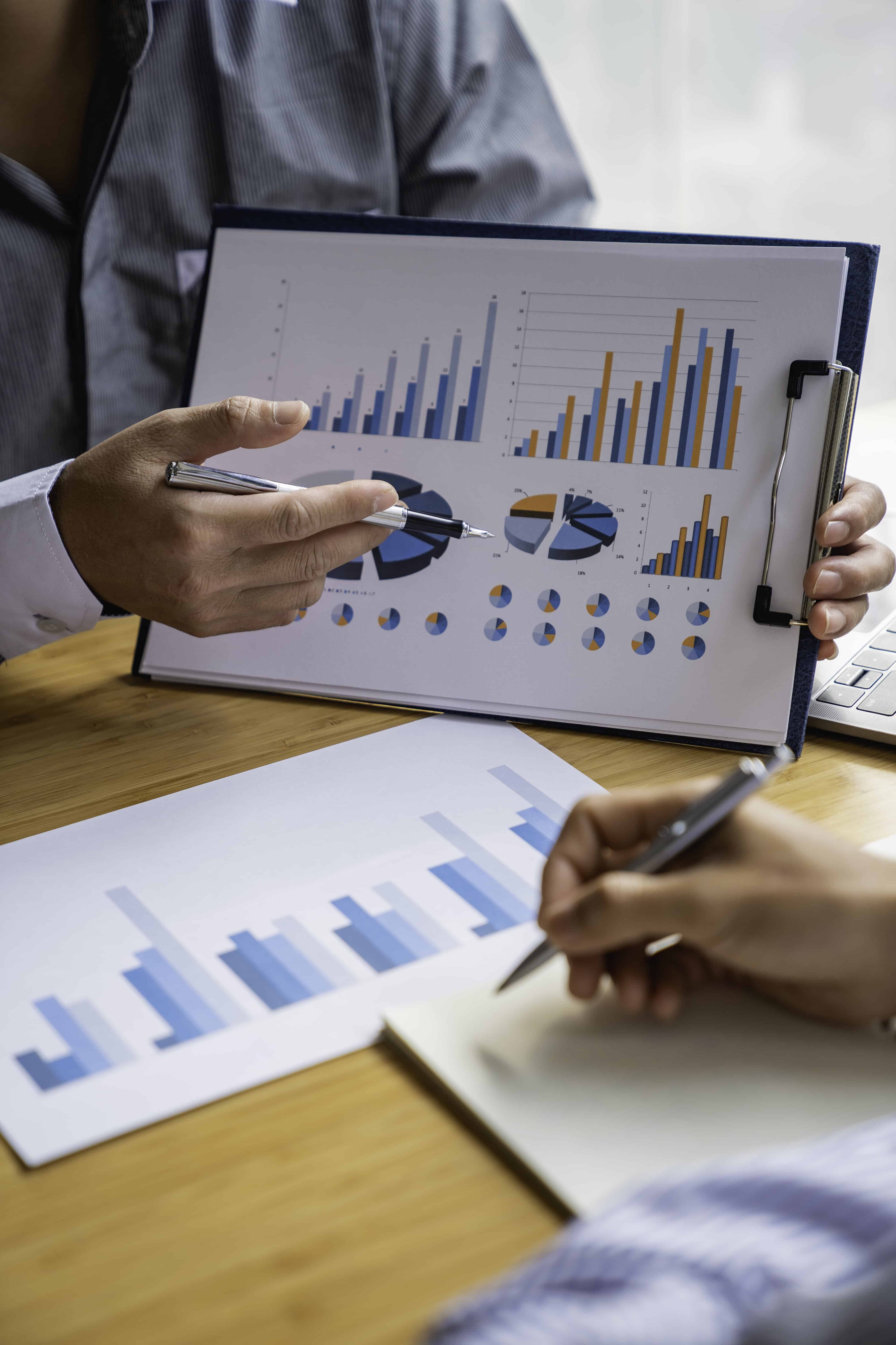 Business professionals analyzing security-level data with charts and graphs.