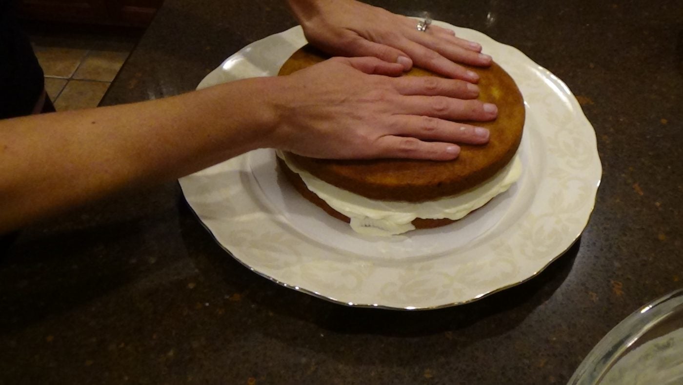 butter cream cheese frosting layered between pumpkin cake