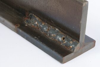 Closeup of welding porosity on a weld coupon