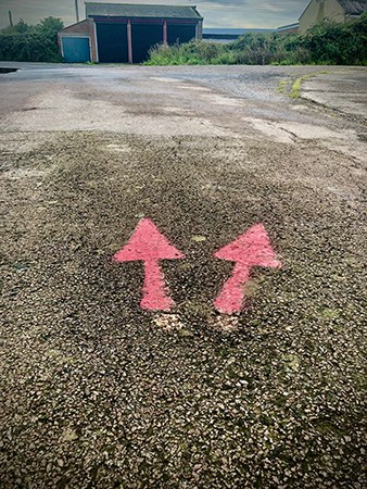 Example of low tech wayfinding design - Painted arrows on tarmac - Orford Ness