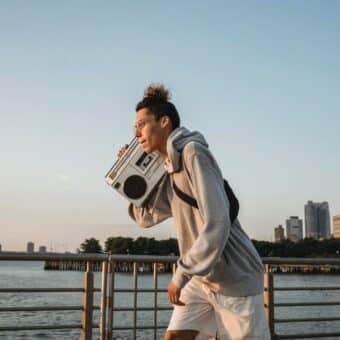 Man with boombox on blue sky