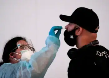 A traveler receives a nasal swab at Tom Bradley International Terminal at Los Angeles International Airport