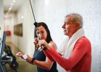 A senior man exercises with a personal trainer in the gym, promoting health and fitness., tags: brits - pexel