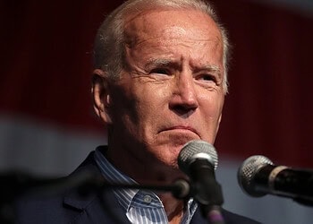 Distressed man speaking into microphones, emotional expression at political event or press conference.