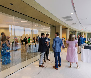 Coworkers mingle in the mezzanine of 1000 Social, a luxury office and event space in Raleigh