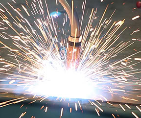 Close up image of a MIG gun with sparks as bright as fireworks