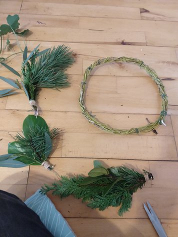 bunches of leaf material and wreath base