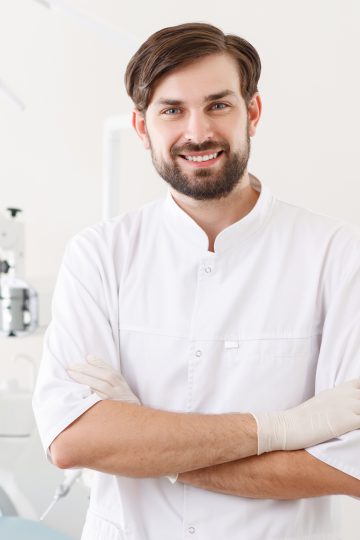 smile-dentist Male dentist smiling in uniform