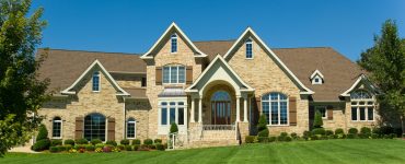 picture of large home with a great green lawn courtesy of a lawn care business